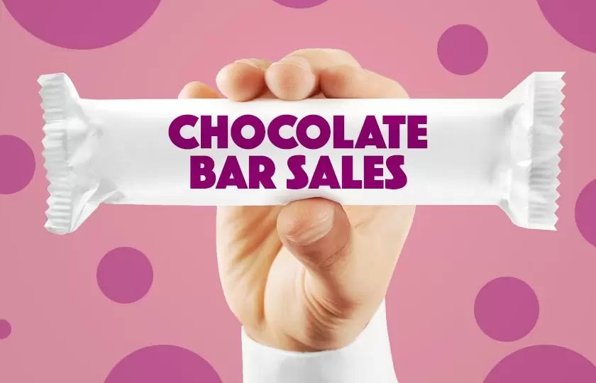 A keen hand, excitedly holding a chocolate bar - key lines for any confectionery retailer!